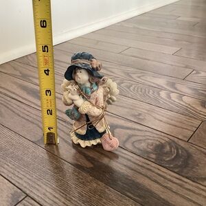 Charming Figurine with Heart Tag